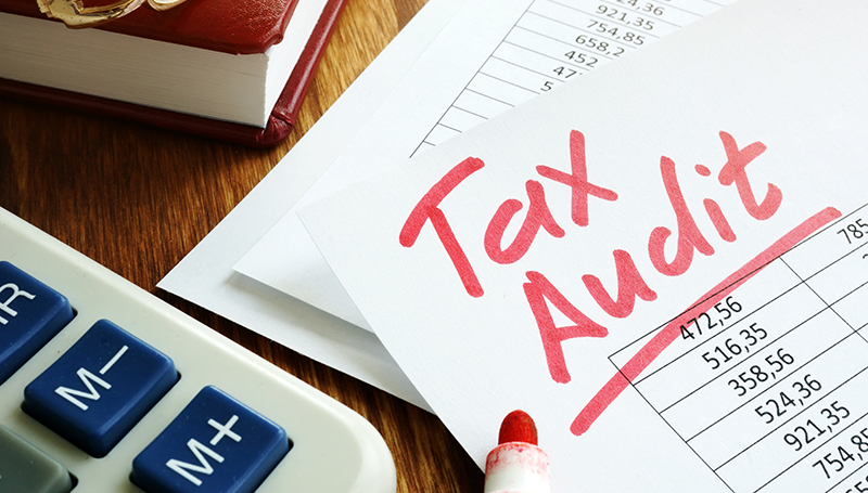 Tax audit handwriting on business accounting documents.