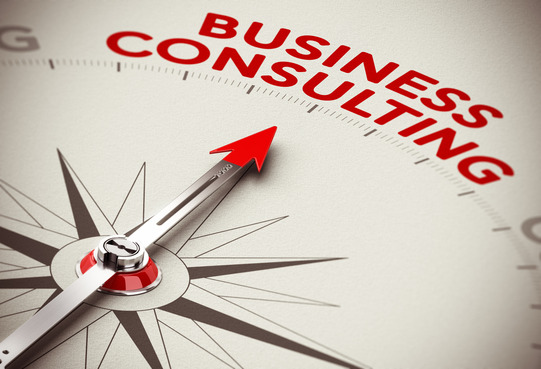 Realistic concept of strategic business. Compass needle pointing the red word business consulting over a paper background